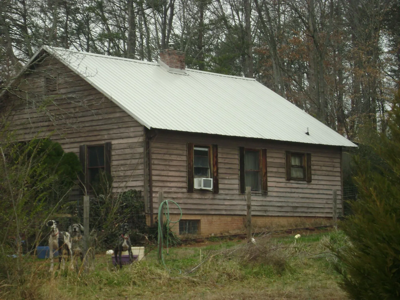 White metal roof on an old wood sided farmhouse, from a Metal Roof Installation job in North Webster